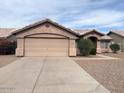 Single-story house featuring a two-car garage, desert landscaping and a neutral color scheme at 60 W Shamrock St, Gilbert, AZ 85233