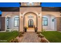 Close up of front entrance with covered portico, decorative lighting, and ironwork at 6378 S 154Th St, Gilbert, AZ 85298