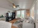 Cozy living room features wood beam, bright windows, and a stylish seating arrangement at 652 S Ellsworth Rd # 46, Mesa, AZ 85208