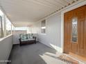 Inviting covered patio with comfortable seating, offering a relaxing outdoor space with decorative glass door at 652 S Ellsworth Rd # 46, Mesa, AZ 85208