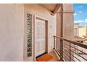 Condo front door with railing and light-filled side panel at 7609 E Indian Bend Rd # 2008, Scottsdale, AZ 85250