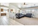 Bright living room featuring neutral carpet, large windows, and contemporary furniture at 7712 N 54Th Ln, Glendale, AZ 85301