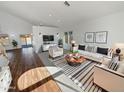 Bright living room with wood floors, a white sofa, and a large window at 8722 W Wilshire Dr, Phoenix, AZ 85037