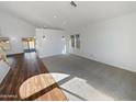 Spacious living room featuring a combination of hardwood floors and carpeted areas at 8722 W Wilshire Dr, Phoenix, AZ 85037