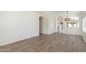 Open-concept living space with hardwood floors and neutral walls, offering a clean and airy feel at 10814 W Alvarado Rd, Avondale, AZ 85392