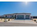Charming single-story home featuring a desert landscape, a gray color palette, and a three-car garage at 11242 E Crescent Ave, Mesa, AZ 85208