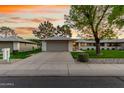 Charming single-story home featuring a spacious two-car garage and well-maintained landscaping with mature trees at 12703 W Shadow Hills Dr, Sun City West, AZ 85375