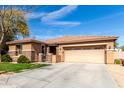 Welcoming single-story home showcasing stone accents, green lawn, and an attached two-car garage at 15590 W Montecito Ave, Goodyear, AZ 85395