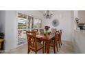 Elegant dining room with a wooden table, seating for six, and sliding glass doors to the patio at 15642 W Arbor Trl, Surprise, AZ 85374