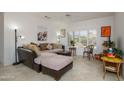 Bright living room with plush seating, tile floors, and a large window with stylish shutters at 15642 W Arbor Trl, Surprise, AZ 85374