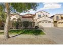 Charming two-story home featuring well-manicured lawn, mature trees, and a three-car garage with plenty of parking space at 16018 W Shangri La Rd, Surprise, AZ 85379