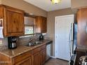 A functional kitchen with a stainless-steel sink and appliances with wood cabinets at 16657 E Gunsight Dr # 182, Fountain Hills, AZ 85268