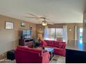 A cozy living room with a ceiling fan, a flatscreen TV and views of the outdoors at 16657 E Gunsight Dr # 182, Fountain Hills, AZ 85268
