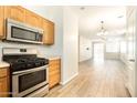 The kitchen features stainless steel appliances and an open view into the living area at 17350 W Adams St, Goodyear, AZ 85338