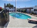 Sparkling community pool with clear blue water, surrounded by a secure fence and lounge seating at 2401 N 70Th St # G, Scottsdale, AZ 85257