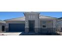 Beautiful single-story home with neutral colors, a two-car garage, and appealing desert landscaping at 25449 W Graham Trl, Buckeye, AZ 85326