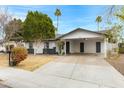 This home features a carport and well-maintained landscaping at 2593 E Commonwealth Cir, Chandler, AZ 85225