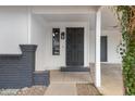 Covered front porch with security door and decorative brick accents at 2593 E Commonwealth Cir, Chandler, AZ 85225