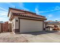 Side view of a two car garage with a well-manicured lawn in front of a charming home at 28422 N 32Nd Ln, Phoenix, AZ 85083