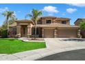Charming two-story home with a well-manicured lawn, a three-car garage, and beautiful palm trees at 3410 E Pageant Pl, Gilbert, AZ 85297