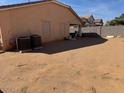 Spacious backyard featuring a block wall fence, offering privacy, and an area for outdoor activities at 36452 W Velazquez Dr, Maricopa, AZ 85138