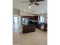 Spacious kitchen featuring an island, dark cabinetry, and stainless steel appliances at 36452 W Velazquez Dr, Maricopa, AZ 85138