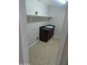 Functional laundry room with storage cabinets and a built-in sink at 36452 W Velazquez Dr, Maricopa, AZ 85138