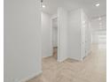 Hallway featuring neutral tile floors and white walls leading to other rooms in the home at 3806 N Camden Dr, Florence, AZ 85132