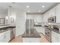 A modern kitchen with stainless steel appliances, granite countertops, and an island, offering ample space at 3935 E Blue Spruce Ln, Gilbert, AZ 85298