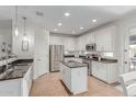 Bright, white kitchen featuring stainless steel appliances, granite countertops, and a functional center island at 3935 E Blue Spruce Ln, Gilbert, AZ 85298
