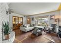 Inviting living room featuring a cozy seating arrangement, stylish decor, and ample natural light from the large windows at 4308 E Montecito Ave, Phoenix, AZ 85018