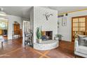 Elegant living room with a brick fireplace, stylish bar cart, and charming decor for a sophisticated ambiance at 4308 E Montecito Ave, Phoenix, AZ 85018