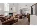 Bright living room features a fireplace, hardwood floors, and vaulted ceilings at 5032 W Yearling Rd, Phoenix, AZ 85083