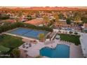 Beautiful aerial view of the home with a tennis court, pool, and outdoor entertainment area at 5532 E Crocus Dr, Scottsdale, AZ 85254
