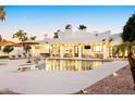 A beautiful backyard with a large pool and diving board, as well as outdoor furniture at 5532 E Crocus Dr, Scottsdale, AZ 85254