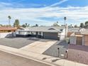 Lovely home with xeriscape front yard, long driveway, and a two-car garage provides ample parking at 6123 W Karen Lee Ln, Glendale, AZ 85306