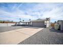 Attractive single-Gathering home with a low-maintenance desert front yard and an attached two-car garage at 6123 W Karen Lee Ln, Glendale, AZ 85306