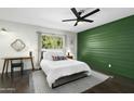Serene bedroom featuring a queen-size bed, a green accent wall, and a cozy atmosphere with great natural light at 6845 E Osborn Rd # D, Scottsdale, AZ 85251