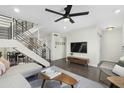 Open concept living room showcasing a modern staircase, entertainment center, and comfortable seating area at 6845 E Osborn Rd # D, Scottsdale, AZ 85251
