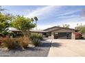Stunning home with a spacious driveway, lush greenery, and desert landscaping at 7508 N 21St St, Phoenix, AZ 85020