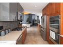 Modern kitchen with stainless steel appliances and sleek cabinetry, perfect for cooking at 7508 N 21St St, Phoenix, AZ 85020