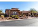 Charming desert home with a tile roof and a welcoming front yard with cacti and xeriscaping at 8041 E Teton Cir, Mesa, AZ 85207