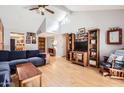 Bright living room with wood floors, vaulted ceilings, and a comfortable blue sectional at 9059 E Winchcomb Dr, Scottsdale, AZ 85260