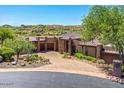 Stunning desert home with stone accents, circular driveway, and manicured landscaping in a beautiful natural setting at 10224 N Azure Vista Trl, Fountain Hills, AZ 85268