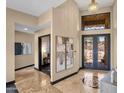 Elegant foyer featuring high ceilings, decorative ironwork, marble floors, and a glimpse into the adjacent office space at 10224 N Azure Vista Trl, Fountain Hills, AZ 85268