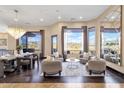 Bright living room with luxury furniture, dark wood floors, designer chandelier, and large windows showcasing mountain views at 10224 N Azure Vista Trl, Fountain Hills, AZ 85268