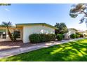 Beautiful community with lush landscaping and mature foliage accenting the warm exteriors at 10511 W Wheatridge Dr, Sun City, AZ 85373