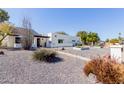 Modern home featuring a white facade, desert landscaping, and a covered entryway at 12236 N 59Th St, Scottsdale, AZ 85254