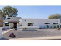 Stunning home with desert landscaping and modern architecture, including a sleek garage door at 12236 N 59Th St, Scottsdale, AZ 85254