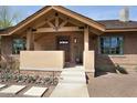 Craftsman home with a cozy front porch, complemented by brick accents and decorative stone landscaping at 130 W Palm Ln, Phoenix, AZ 85003